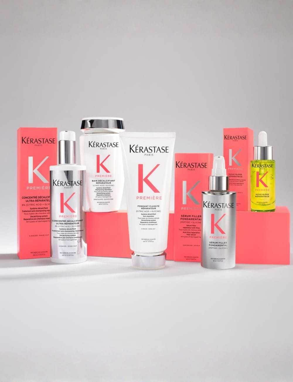 Kérastase hair care products arranged on a display with pink and white packaging.